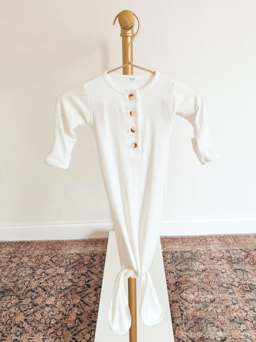 white baby gown with buttons